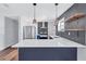 Bright, updated kitchen with stainless steel appliances, herringbone backsplash, and wood shelves at 1328 Sharon Street Nw, Atlanta, GA 30314