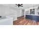 Open-concept kitchen with stainless steel appliances, a kitchen island, and hardwood flooring at 1328 Sharon Street Nw, Atlanta, GA 30314