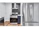 Close-up of stainless steel kitchen appliances with modern stove, range hood and refrigerator at 1328 Sharon Street Nw, Atlanta, GA 30314