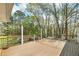 View from deck with brown railings, overlooking the backyard, trees and landscaping at 195 Creekside Way, Mcdonough, GA 30252