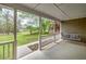 Relaxing covered back porch with a swing overlooking the lawn at 195 Creekside Way, Mcdonough, GA 30252