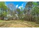 Large backyard featuring mature trees and a quaint storage shed at 195 Creekside Way, Mcdonough, GA 30252