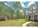 Picturesque backyard featuring a well-maintained lawn, mature trees, and a charming shed for extra storage at 195 Creekside Way, Mcdonough, GA 30252