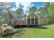 Large deck and screened in back porch with green lawn and mature trees at 195 Creekside Way, Mcdonough, GA 30252