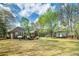 Expansive backyard with lush greenery and a charming storage shed at 195 Creekside Way, Mcdonough, GA 30252