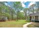 Backyard showcasing a patio, shed, and walkway leading to the home with mature trees at 195 Creekside Way, Mcdonough, GA 30252