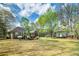 Expansive backyard with lush greenery and a charming outbuilding, offering a serene outdoor space at 195 Creekside Way, Mcdonough, GA 30252