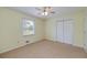 Bright bedroom with carpet flooring, a large window, and a spacious closet at 195 Creekside Way, Mcdonough, GA 30252