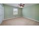 This carpeted bedroom features a ceiling fan, a window and closet at 195 Creekside Way, Mcdonough, GA 30252