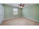 Neutral bedroom featuring a ceiling fan and a window providing natural light at 195 Creekside Way, Mcdonough, GA 30252