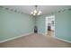 Dining room featuring carpet flooring, classic chandelier, and vintage wallpaper at 195 Creekside Way, Mcdonough, GA 30252