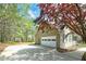 Side view of the house featuring a two-car garage and long driveway at 195 Creekside Way, Mcdonough, GA 30252