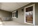 Charming front porch features a porch swing and glass-paneled front door with sidelights at 195 Creekside Way, Mcdonough, GA 30252