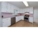 Bright kitchen features white cabinets, stainless steel appliances, and a cozy breakfast area at 195 Creekside Way, Mcdonough, GA 30252