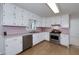 Well-lit kitchen featuring white cabinets, stainless steel appliances, and modern fixtures at 195 Creekside Way, Mcdonough, GA 30252