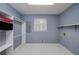 Functional laundry room with tile floors, shelving, and ample space at 195 Creekside Way, Mcdonough, GA 30252