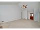 Spacious living room with vaulted ceilings, ceiling fan and a wooden front door at 195 Creekside Way, Mcdonough, GA 30252