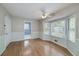 Bright living room featuring hardwood floors, bay windows, and a ceiling fan at 195 Creekside Way, Mcdonough, GA 30252