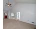 Open-concept living room with vaulted ceiling, ceiling fan, and access to dining and kitchen at 195 Creekside Way, Mcdonough, GA 30252