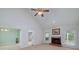 Bright living room with a fireplace, views of the backyard, and a ceiling fan at 195 Creekside Way, Mcdonough, GA 30252