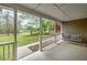 Covered porch with a swing and view of the green front yard at 195 Creekside Way, Mcdonough, GA 30252