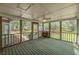 Relaxing screened-in back porch with views of the backyard and surrounding trees at 195 Creekside Way, Mcdonough, GA 30252