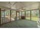 Relaxing screened porch with ceiling fan and views of the wooded backyard at 195 Creekside Way, Mcdonough, GA 30252