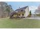 Spacious backyard with a well-maintained lawn, mature trees, and a patio area for outdoor living at 802 Towering Pine Trl, Lawrenceville, GA 30045