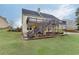 Large, grassy backyard features a patio, tiered decks, mature trees, and ample space at 802 Towering Pine Trl, Lawrenceville, GA 30045