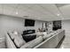 Finished basement with sectional sofa, entertainment center, and modern decor at 802 Towering Pine Trl, Lawrenceville, GA 30045