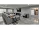 Spacious finished basement featuring a large sectional sofa, TV, and tiled flooring at 802 Towering Pine Trl, Lawrenceville, GA 30045