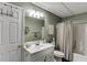 Neat bathroom with a white vanity, mirror, and a shower-tub combination at 802 Towering Pine Trl, Lawrenceville, GA 30045