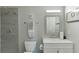 Modern bathroom features a tiled shower, white toilet, vanity, and stylish fixtures, offering a clean aesthetic at 802 Towering Pine Trl, Lawrenceville, GA 30045