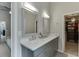 Elegant bathroom features dual sinks, quartz countertops, grey cabinetry and a walk-in closet with a neutral palette at 802 Towering Pine Trl, Lawrenceville, GA 30045