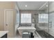 Luxurious bathroom features a modern soaking tub, walk-in shower, and stylish design, creating a spa-like experience at 802 Towering Pine Trl, Lawrenceville, GA 30045