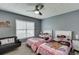 Charming bedroom featuring two twin beds, a cozy couch, and ample natural light at 802 Towering Pine Trl, Lawrenceville, GA 30045