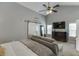 Bright, spacious bedroom with vaulted ceilings, comfy seating, and a TV, creating a relaxing retreat at 802 Towering Pine Trl, Lawrenceville, GA 30045