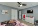 Cozy bedroom features ceiling fan, dresser with TV, and comfortable beds, creating a relaxing retreat at 802 Towering Pine Trl, Lawrenceville, GA 30045