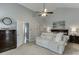 Spacious bedroom boasts vaulted ceilings, plush seating, a cozy bed, and elegant decor art, perfect for relaxation at 802 Towering Pine Trl, Lawrenceville, GA 30045