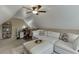 Comfortable bonus room featuring a sectional sofa, desk, and natural light at 802 Towering Pine Trl, Lawrenceville, GA 30045