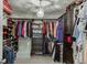 Well-organized walk-in closet with custom shelves, clothing racks, and storage drawers at 802 Towering Pine Trl, Lawrenceville, GA 30045