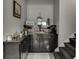 Charming coffee bar with dark cabinets and decorative accents near the staircase at 802 Towering Pine Trl, Lawrenceville, GA 30045
