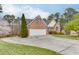 Attractive home with a spacious driveway, lush green lawn, and mature landscaping at 802 Towering Pine Trl, Lawrenceville, GA 30045