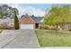 Beautiful brick home with a two-car garage, green lawn, and mature trees at 802 Towering Pine Trl, Lawrenceville, GA 30045
