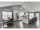 Open-concept living area featuring a kitchen island, dining area, and fireplace, perfect for entertaining at 802 Towering Pine Trl, Lawrenceville, GA 30045