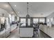 Open-concept kitchen featuring a large island, stainless steel appliances, and flows into the living area at 802 Towering Pine Trl, Lawrenceville, GA 30045