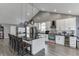 Bright kitchen featuring a large island with black countertop, modern appliances, and pendant lighting at 802 Towering Pine Trl, Lawrenceville, GA 30045