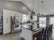 Bright kitchen featuring a large island with black countertop, modern appliances, and pendant lighting at 802 Towering Pine Trl, Lawrenceville, GA 30045