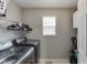 Functional laundry room featuring modern washer and dryer units, storage shelves, and natural light at 802 Towering Pine Trl, Lawrenceville, GA 30045