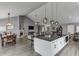 Open-concept living area featuring a kitchen island, dining area, and fireplace, perfect for entertaining at 802 Towering Pine Trl, Lawrenceville, GA 30045